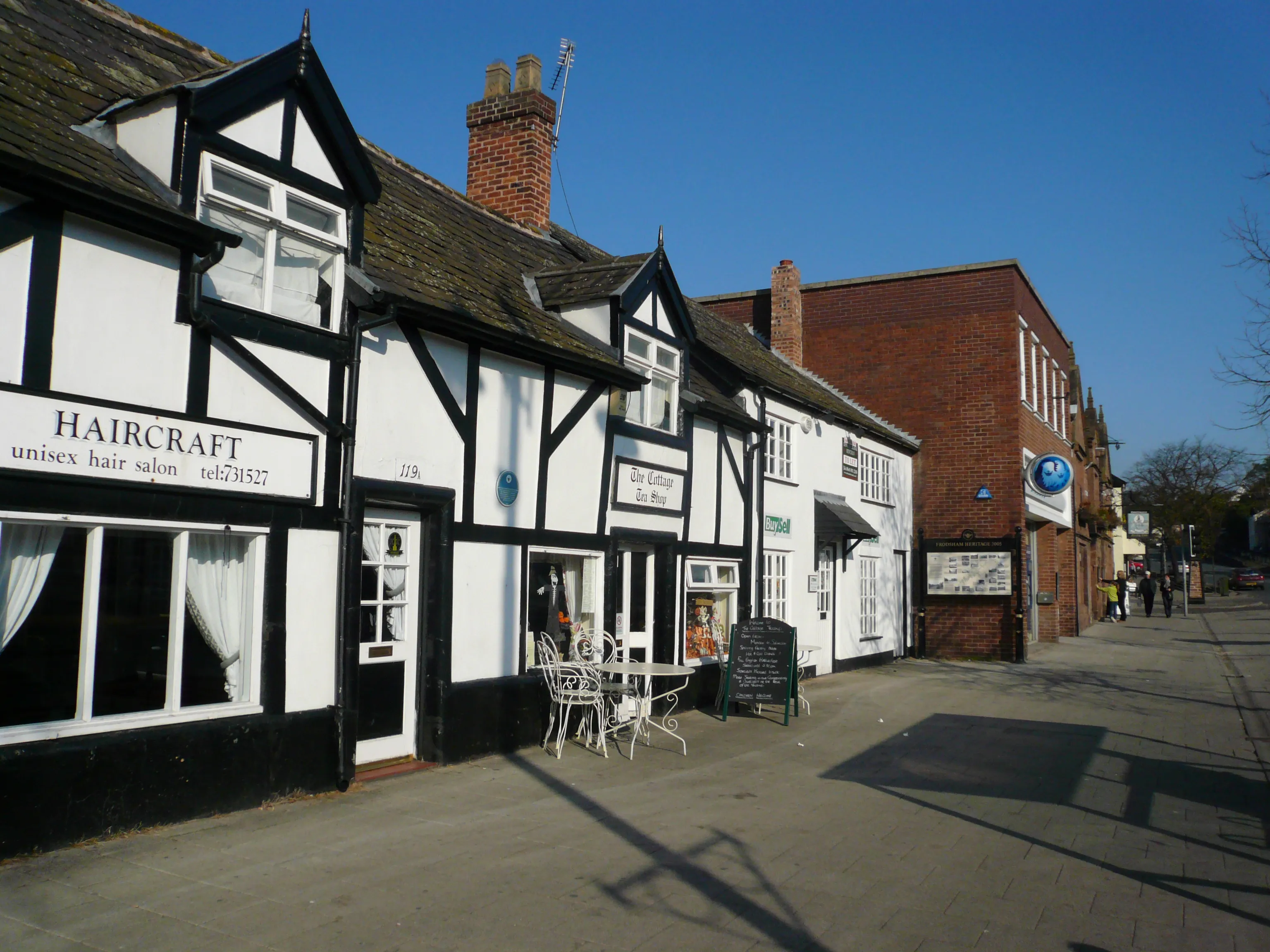 Shops and period buildings on Frodsham High Street, a Cheshire market town we serve