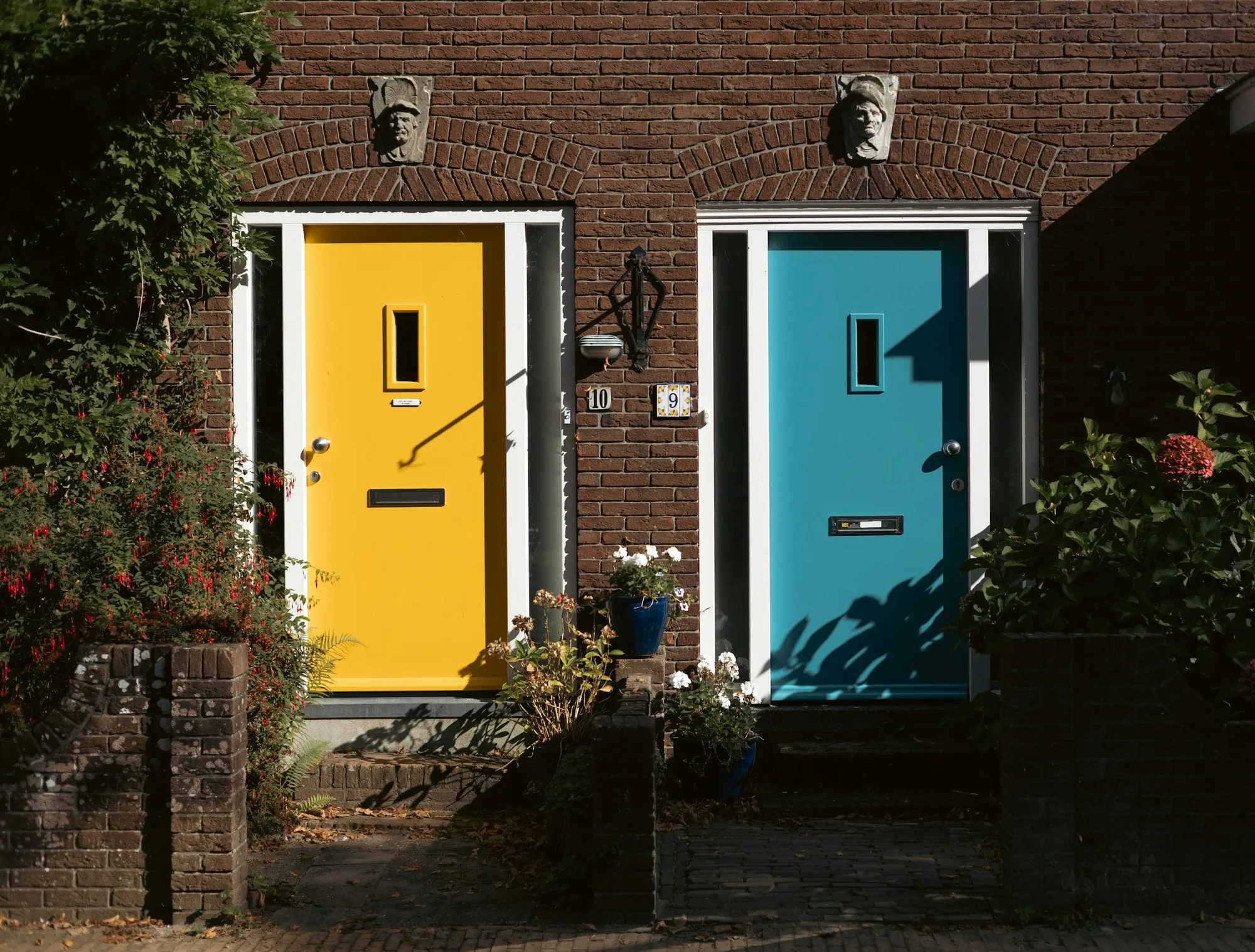 Colourful composite front doors on a traditional British brick terrace — a common feature of Chester streets